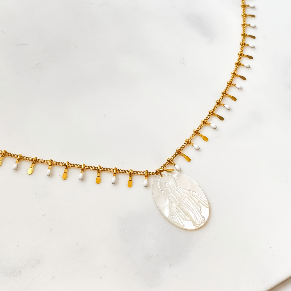 Le collier long Mary Vierge blanche est une pièce d'une élégance intemporelle. Avec sa chaîne délicate et son pendentif représentant la Vierge Marie, il évoque une aura de pureté et de grâce. Sa couleur blanche lumineuse ajoute une touche de douceur à n'importe quelle tenue. Porté avec un simple t-shirt ou une robe élégante, ce collier ajoute une touche de sophistication discrète. Parfait pour ajouter une note céleste à votre style quotidien