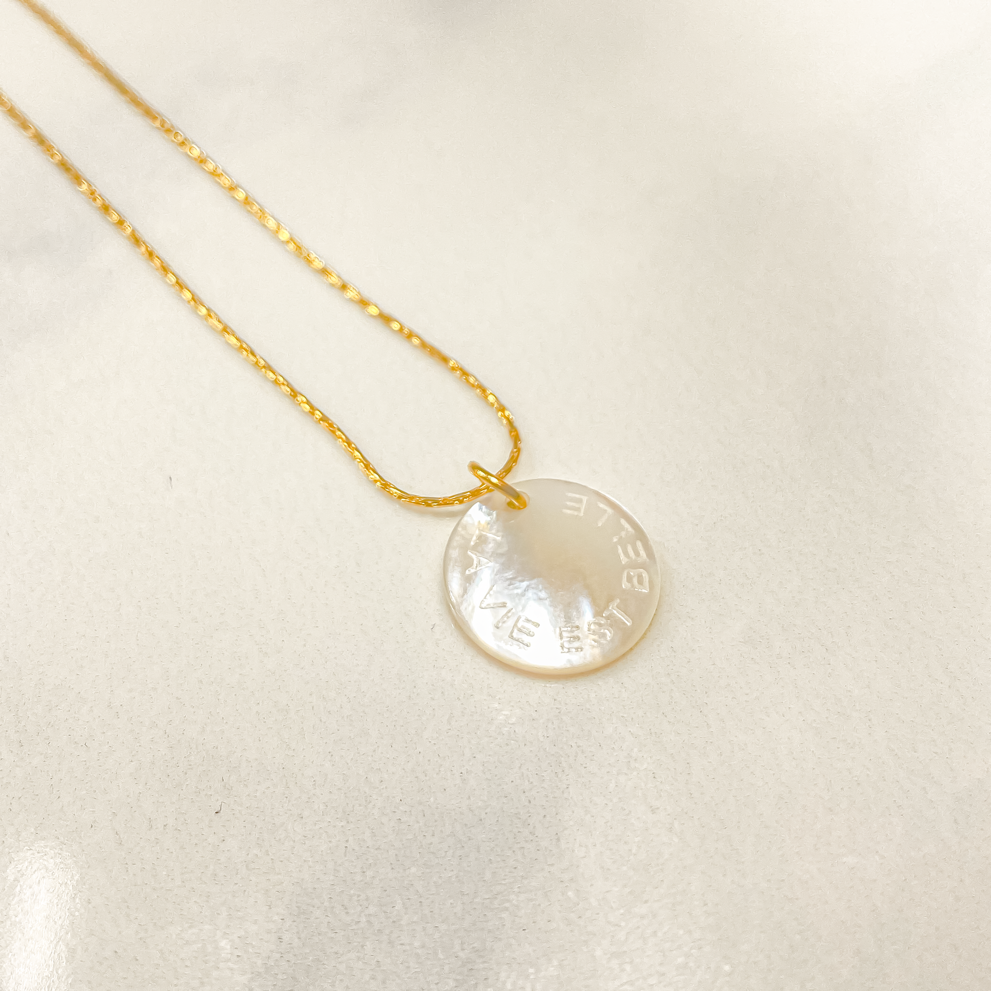 Un collier en acier inoxydable élégant, orné d'un pendentif en nacre délicatement gravé de l'inscription "La vie est belle". Son design minimaliste et sa touche de sophistication en font un accessoire à la fois intemporel et inspirant, rappelant la beauté de la vie à chaque regard. Parfait pour ajouter une touche de positivité et d'élégance à toute tenue.